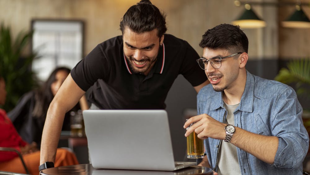 Two men reviewing church management software together at a laptop — evaluating tools is a team decision, not a solo one
